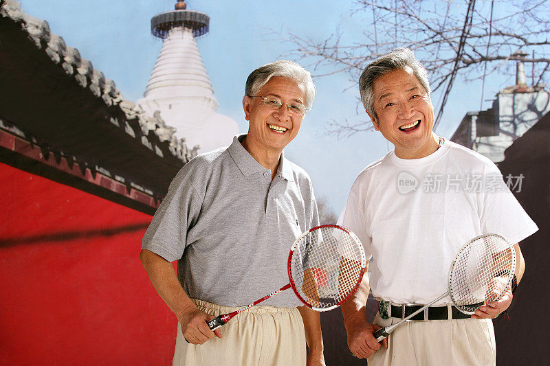 two oriental senior men playing badminton